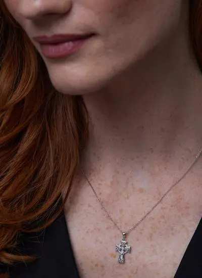 Close up of red haired model wearing Sterling Silver Trinity Knot Celtic Cross with Swarovski Crystals